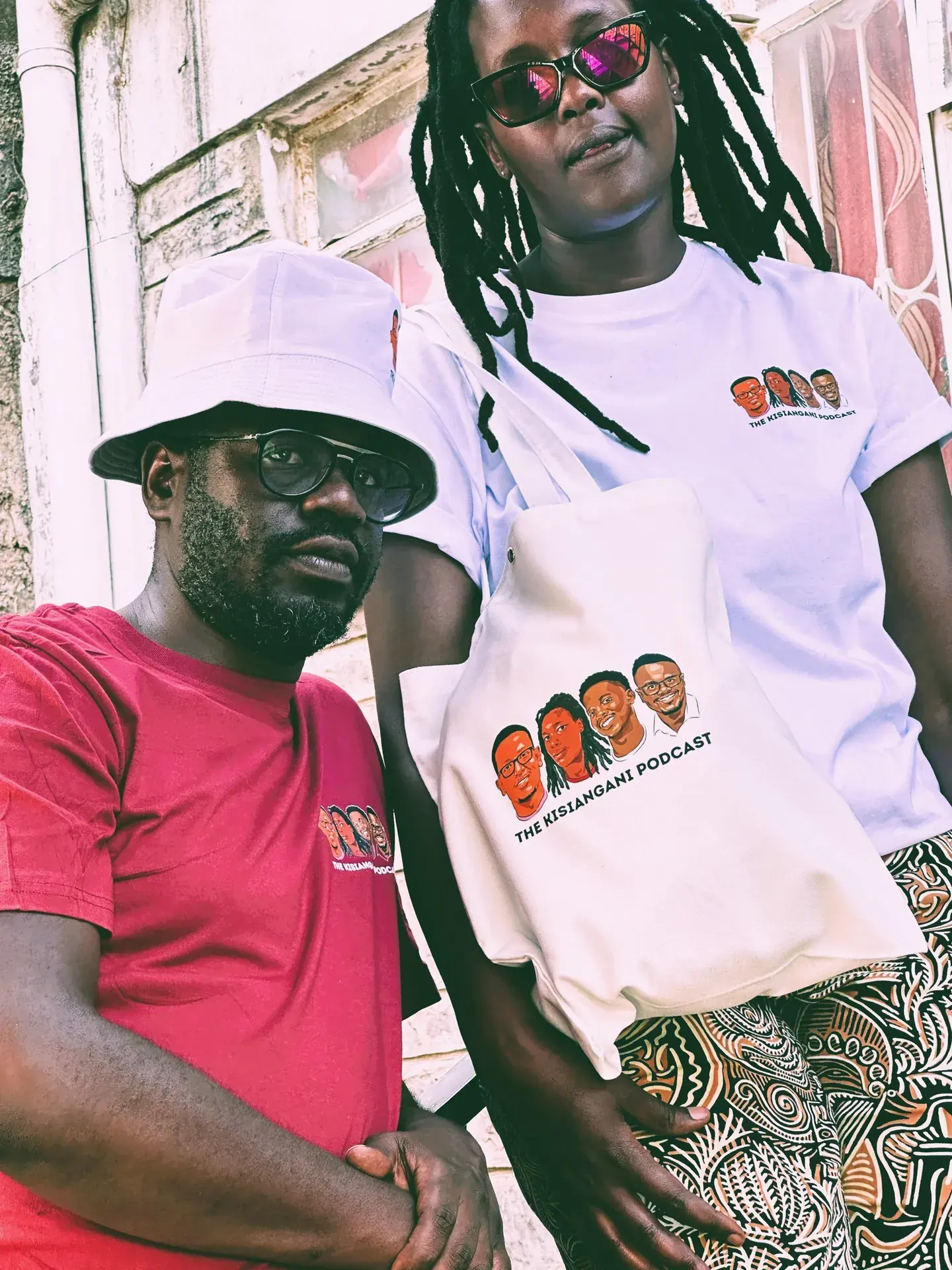 A bucket hat, a red tee, and a tote bag printed with the crew's faces